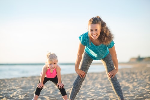 Mom and daughter workout on the beach - San Diego Gym