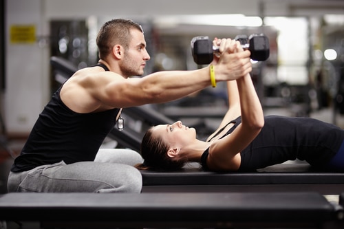 Personal trainer and woman at gym - personal fitness trainer Solana Beach