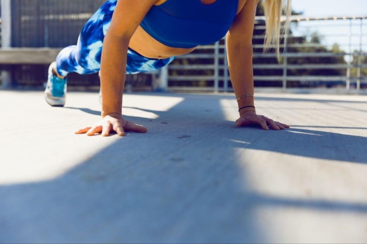 woman doing push-ups at fit atheltic club