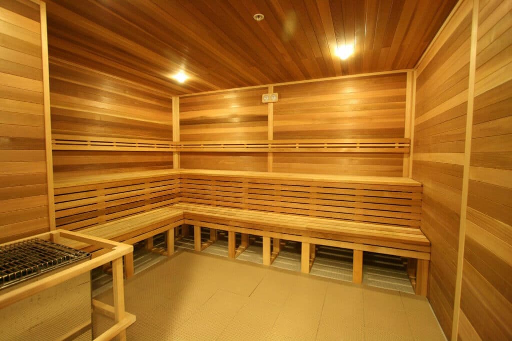 A sauna room with wooden benches and a bench.