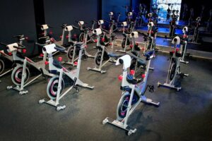 A room full of spinning bikes in a gym.