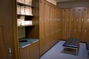 A locker room with a bench and towels.