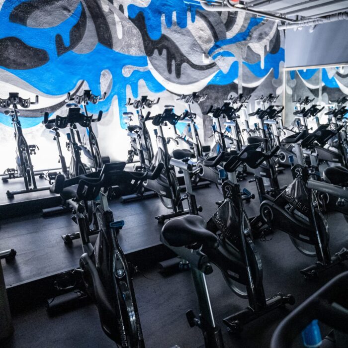 A room full of stationary bikes in a gym.