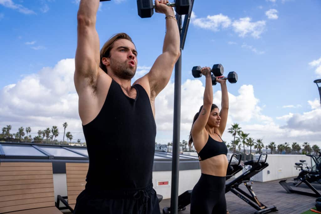A man and woman lifting weights.