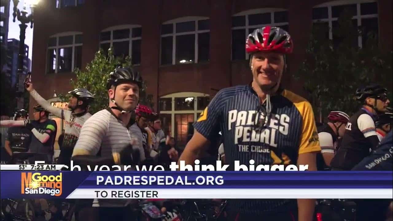 Two cyclists preparing for a group ride at a biking event.